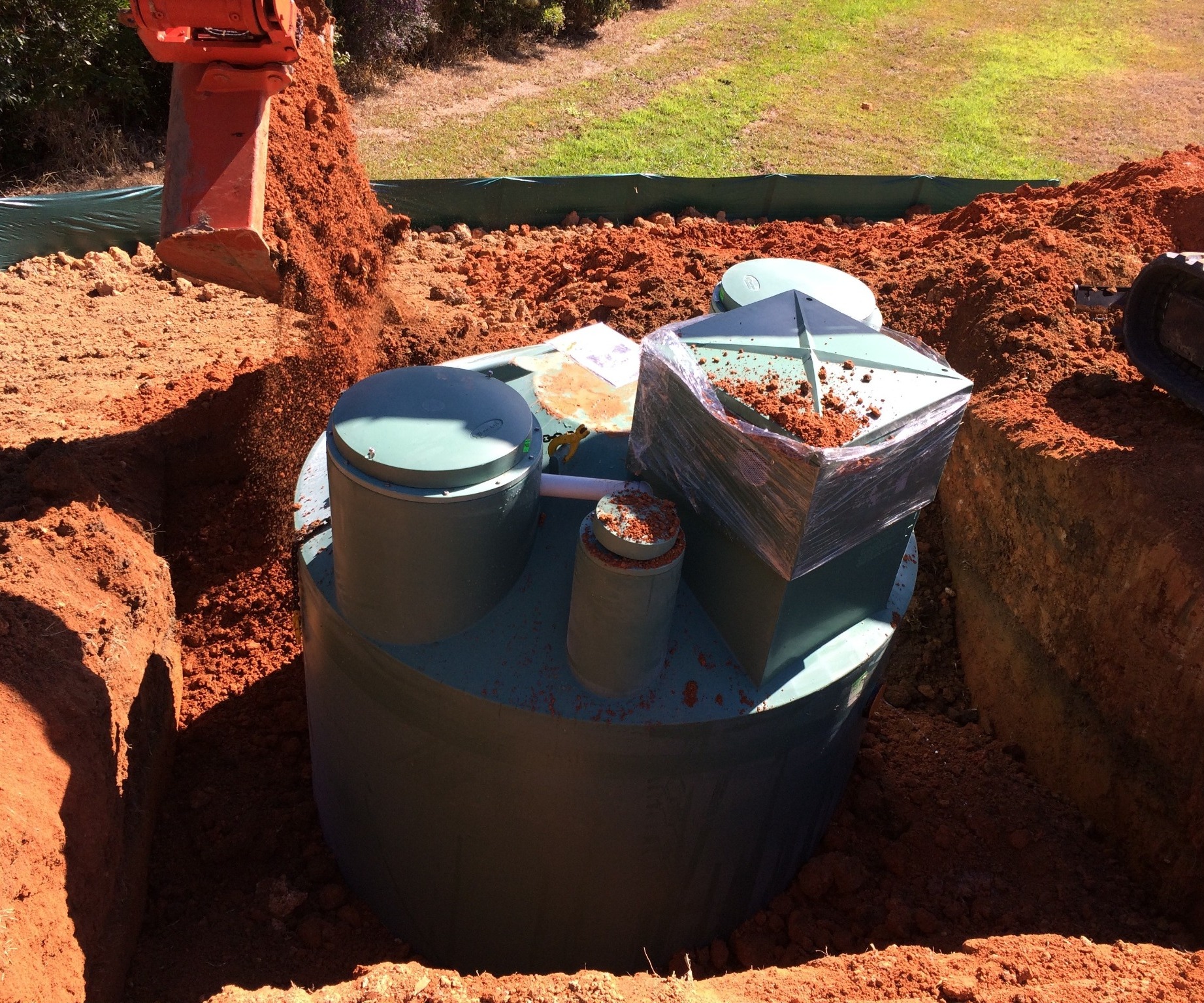 RP10 wastewater treatment system positioned in an excavation during installation